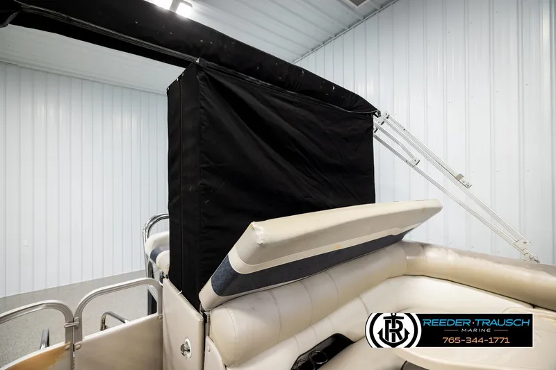 Slide: The Image of 2004 Smoker Craft 820 Infinity Cruise boat interior with black canopy in storage. - 25