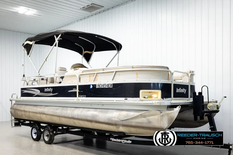 Slide: The Image of 2004 Smoker Craft 820 Infinity Cruise pontoon boat on trailer in indoor storage. - 3