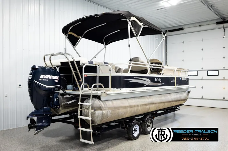 Slide: The Image of 2004 Smoker Craft 820 Infinity Cruise pontoon boat with Evinrude engine in indoor showroom. - 6