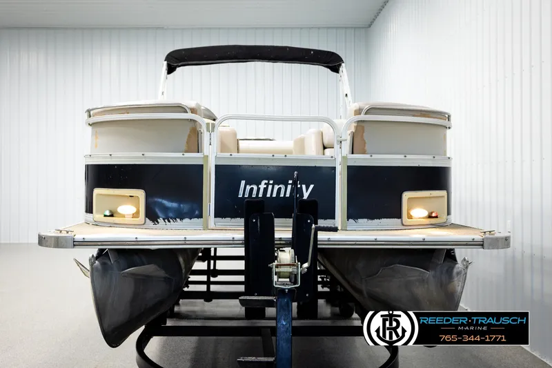 Slide: The Image of 2004 Smoker Craft 820 Infinity Cruise pontoon boat in indoor storage. - 8