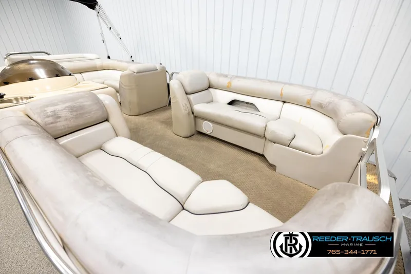 Slide: The Image of 2004 Smoker Craft 820 Infinity Cruise pontoon boat interior with beige seating and carpet. - 9