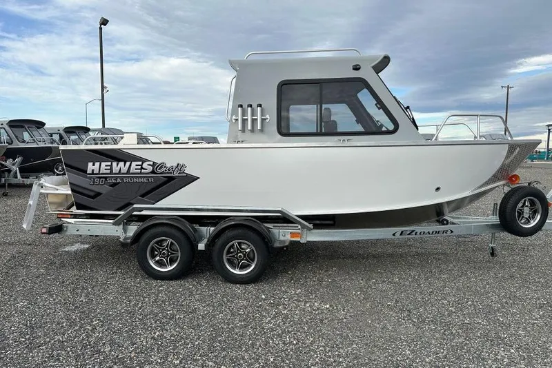 The Image of 2026 Hewescraft 190 Sea Runner Hardtop boat on trailer, parked outdoors. - 1