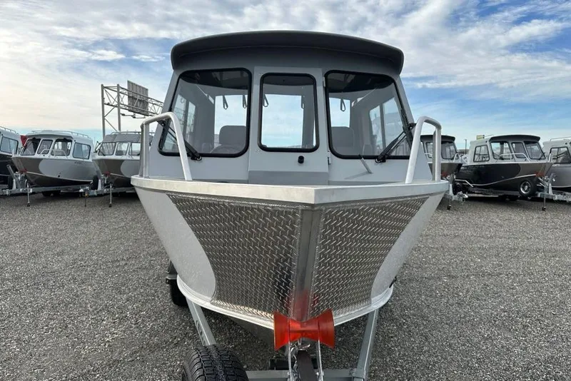 Slide: The Image of 2026 Hewescraft 190 Sea Runner Hardtop boat displayed in a dealership lot. - 3