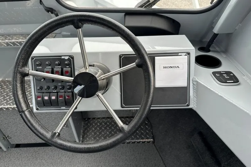 Slide: The Image of Steering wheel and controls of 2026 Hewescraft 190 Sea Runner Hardtop boat. - 7