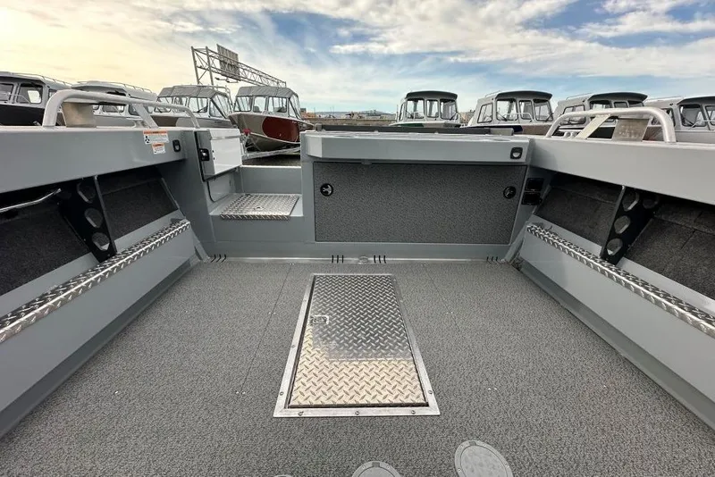 Slide: The Image of 2026 Hewescraft 190 Sea Runner Hardtop interior with spacious deck and storage compartments. - 9