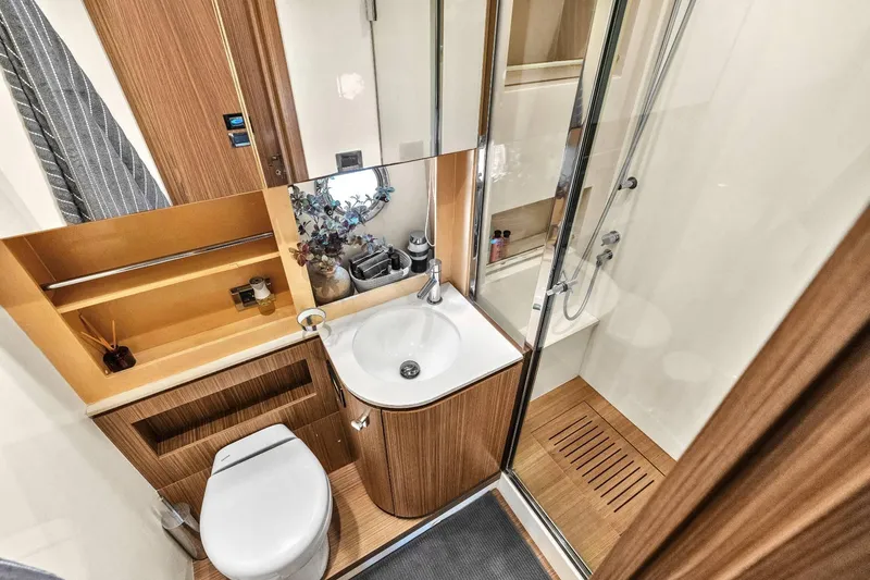 Slide: The Image of Luxurious bathroom in 2014 Azimut Atlantis 48 yacht with modern fixtures and wooden accents. - 17