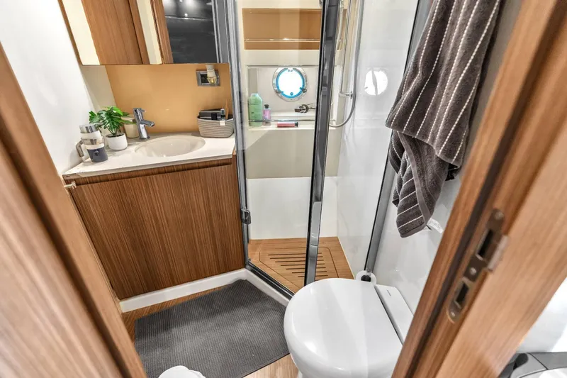 Slide: The Image of Luxurious bathroom in 2014 Azimut Atlantis 48 yacht with modern fixtures and wooden accents. - 20