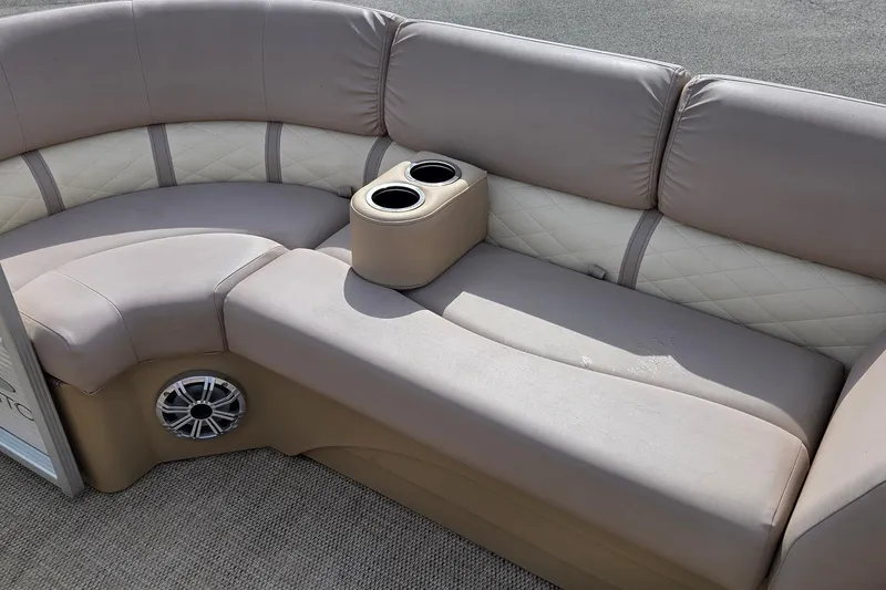 Slide: The Image of 2018 Bennington SX22 boat seating with cup holders and speaker, beige upholstery. - 7