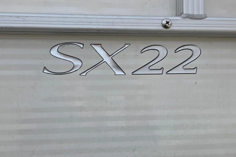 Slide: The Image of 2018 Bennington SX22 model emblem on a metallic surface. - 8