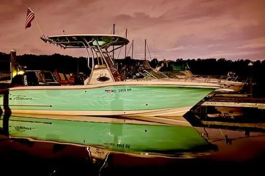 Slide: The Image of 2021 Pioneer 222 Islander boat docked at sunset with water reflection. - 5
