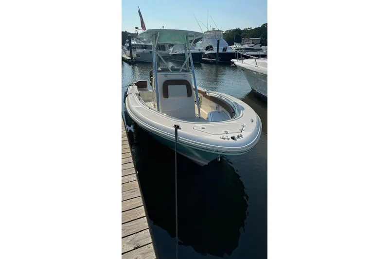 Slide: The Image of 2021 Pioneer 222 Islander boat docked at marina, sunny day, calm water. - 9