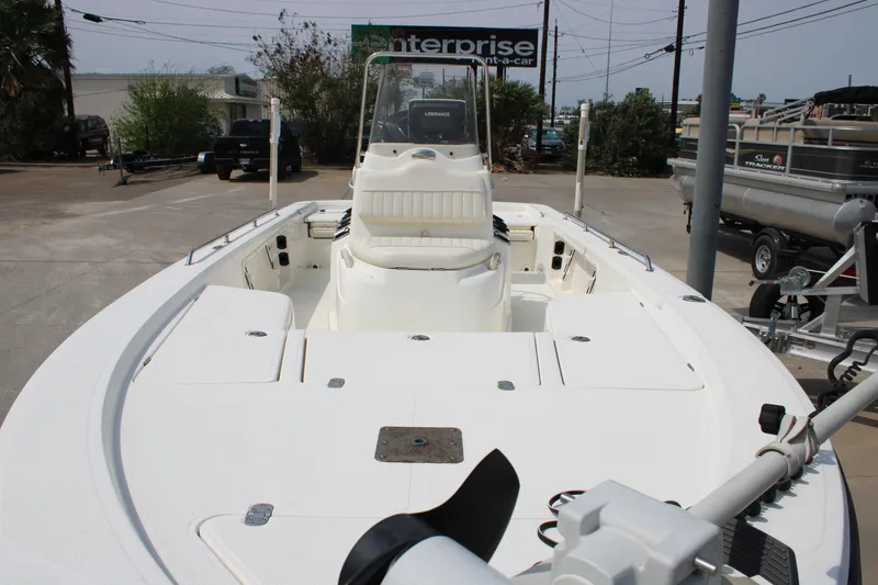 Slide: The Image of 2008 Mako 2201 Tunnel Inshore boat, white interior, parked outdoors. - 10