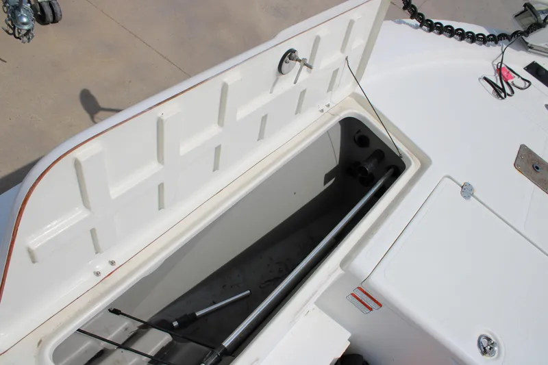 Slide: The Image of Open storage compartment on a 2008 Mako 2201 Tunnel Inshore boat deck. - 12