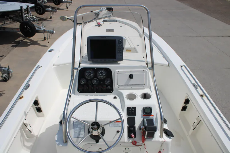 Slide: The Image of 2008 Mako 2201 Tunnel Inshore boat dashboard with steering wheel and navigation equipment. - 13