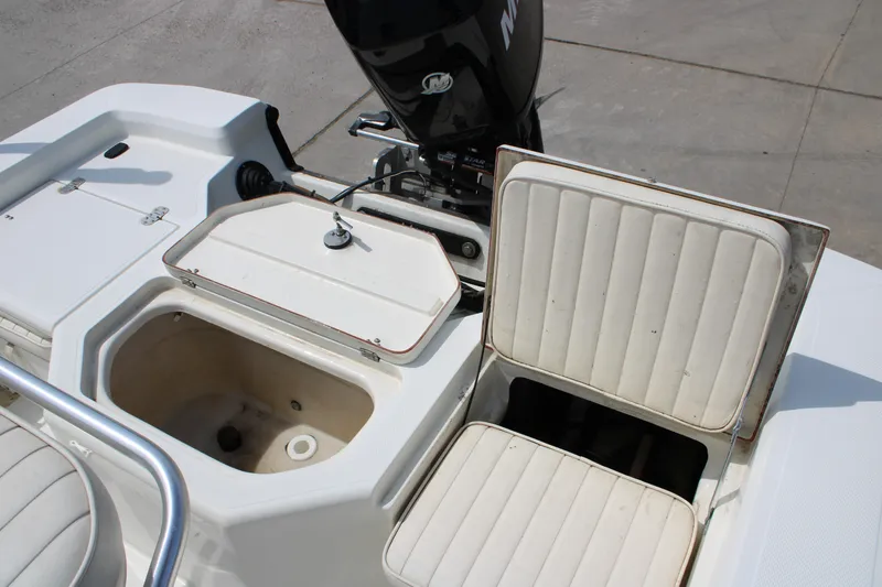 Slide: The Image of 2008 Mako 2201 Tunnel Inshore boat with open storage compartments and cushioned seating. - 14