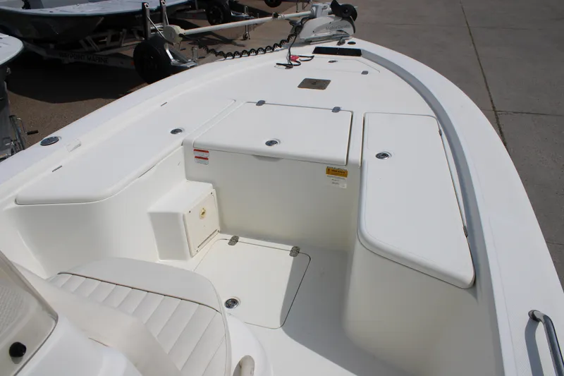 Slide: The Image of 2008 Mako 2201 Tunnel Inshore boat interior with storage compartments and seating. - 16