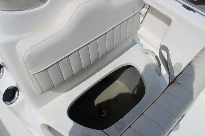 Slide: The Image of 2008 Mako 2201 Tunnel Inshore boat interior with seating and storage compartment. - 17