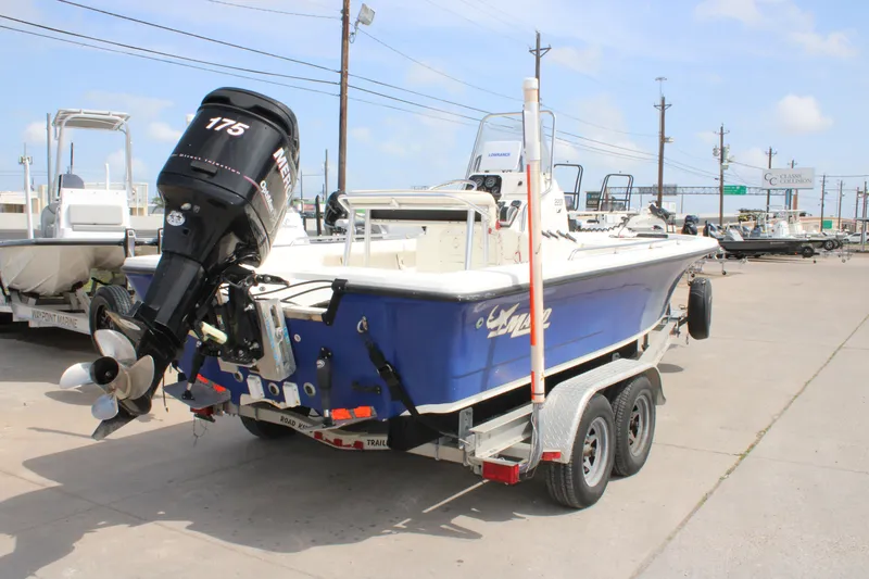 Slide: The Image of 2008 Mako 2201 Tunnel Inshore boat on trailer with outboard motor in marina. - 6