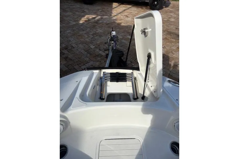 Slide: The Image of 2011 Sea Ray 220 Sundeck boat interior with cushioned seating and speaker. - 10