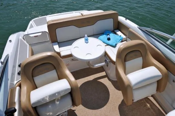 Slide: The Image of Interior seating of 2011 Sea Ray 220 Sundeck boat with beige upholstery. - 13