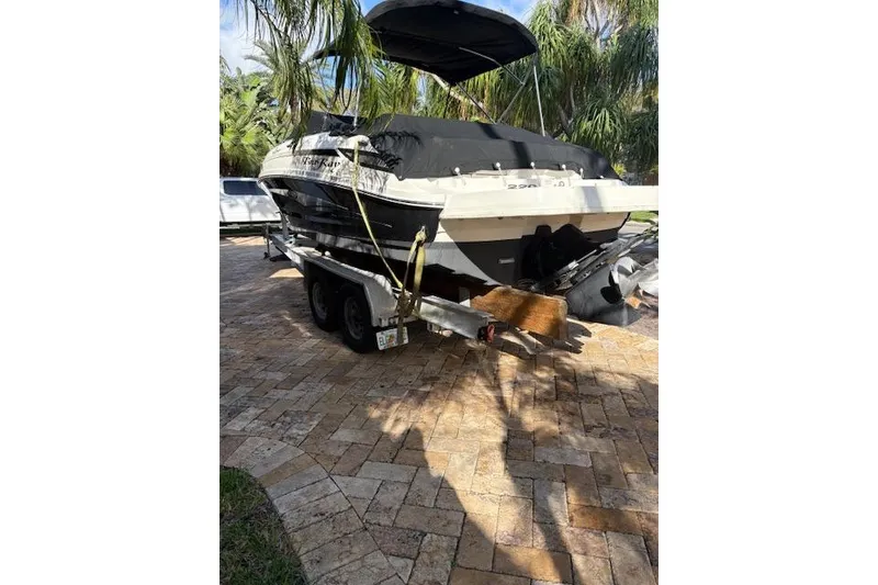 Slide: The Image of 2011 Sea Ray 220 Sundeck engine compartment with open hatch, showcasing interior components. - 16