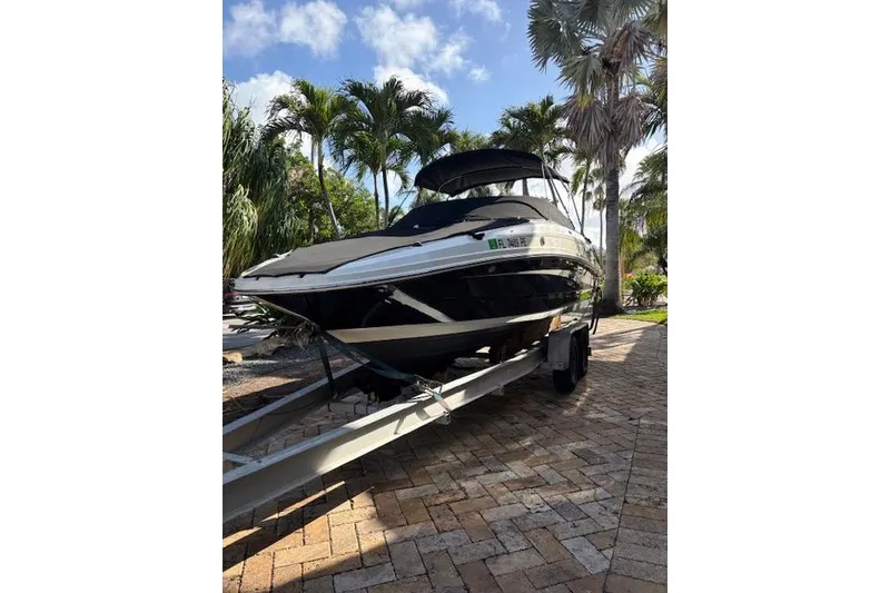 Slide: The Image of 2011 Sea Ray 220 Sundeck boat with ladder and propeller, dockside view. - 19