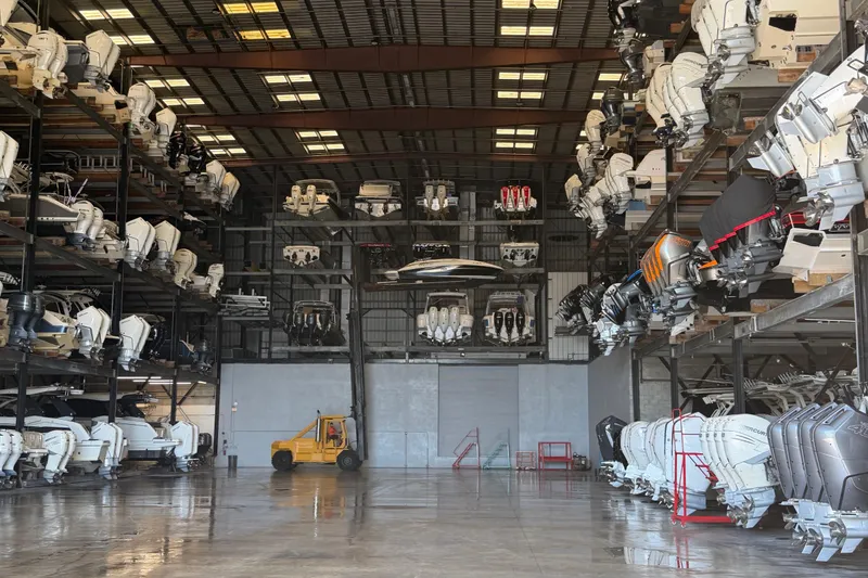 Slide: The Image of Indoor boat storage with multiple vessels, including a 2011 Sea Ray 220 Sundeck. - 23