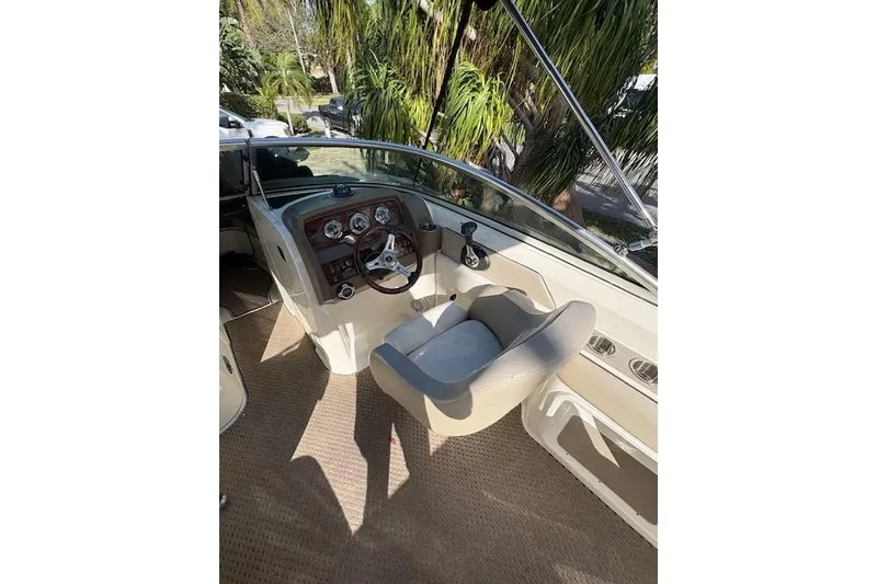 Slide: The Image of Open storage compartment on 2011 Sea Ray 220 Sundeck boat, showing ladder and accessories. - 5
