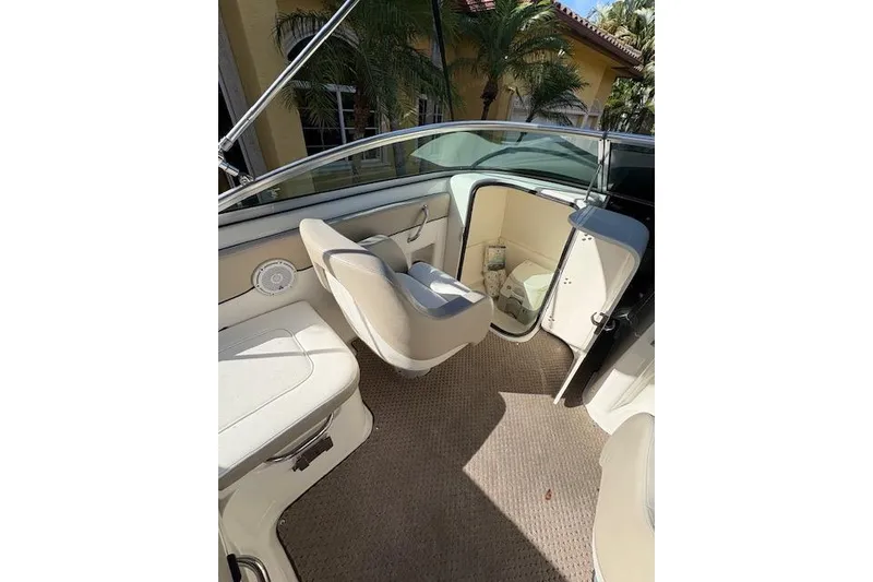 Slide: The Image of 2011 Sea Ray 220 Sundeck boat docked under clear blue sky. - 7