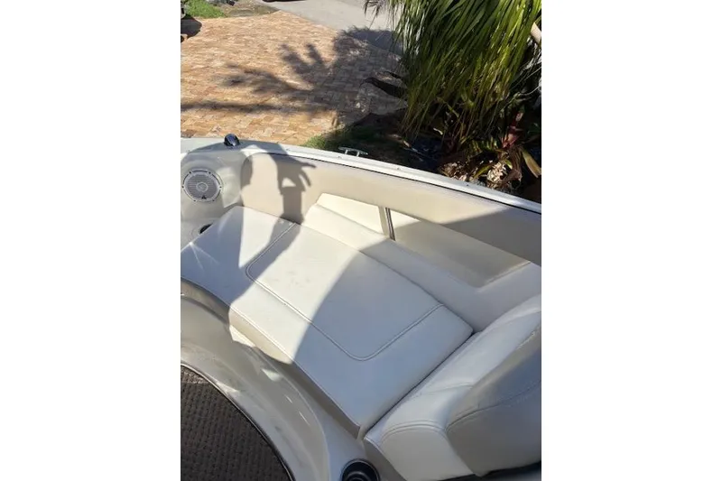 Slide: The Image of 2011 Sea Ray 220 Sundeck interior with white seating and open deck layout. - 9