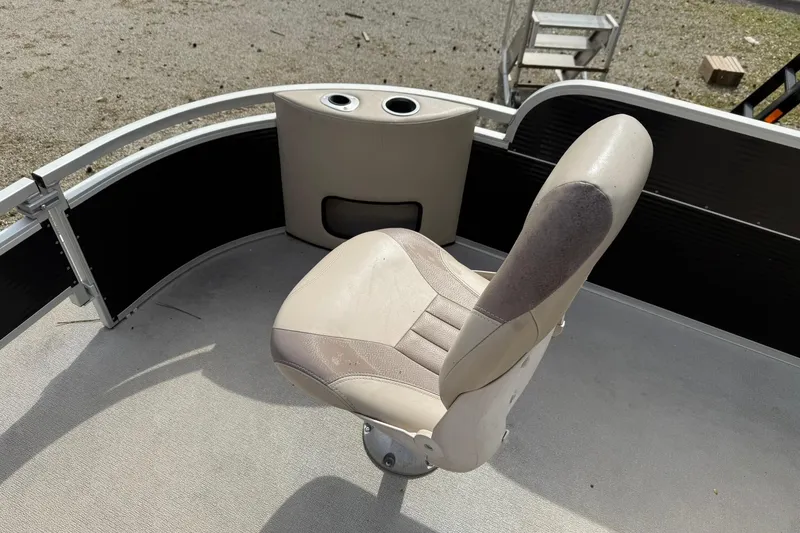 Slide: The Image of Boat seat on 2016 SilverWave 230 Island CC, featuring cup holders and beige upholstery. - 7