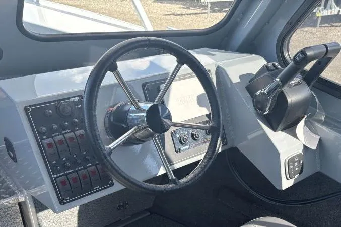 Slide: The Image of Steering console of 2026 Hewescraft 250 Alaskan boat with control panel. - 10