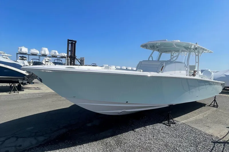 The Image of 2023 Jupiter 40 boat on display at a marina under clear blue sky. - 0