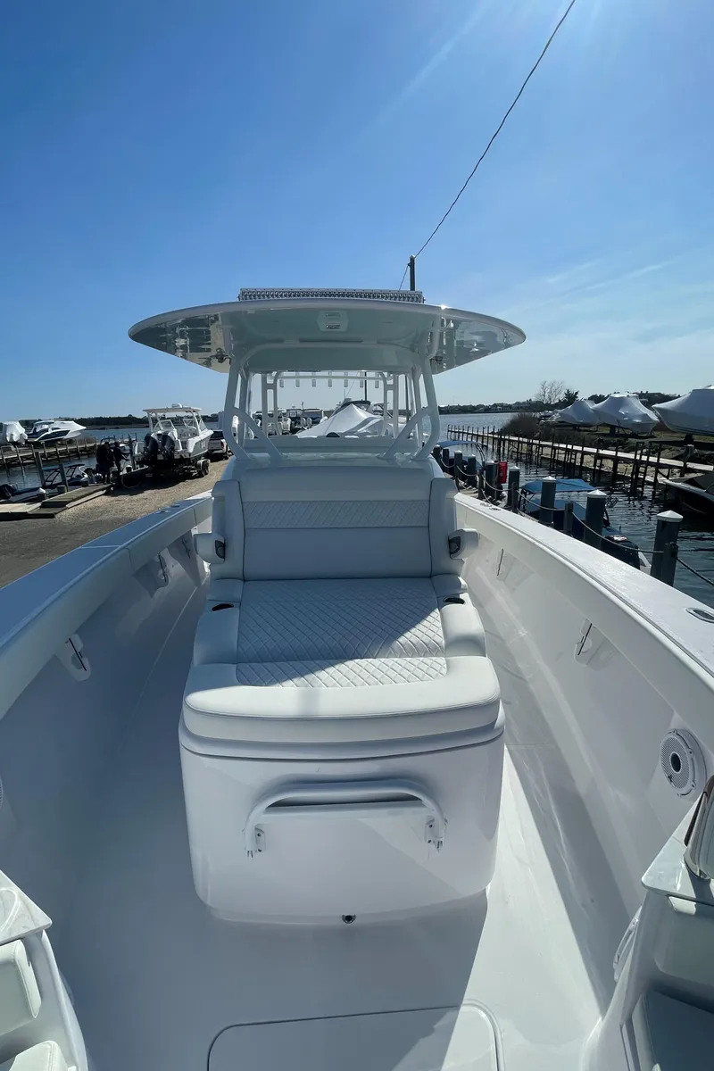 Slide: The Image of 2023 Jupiter 40 boat docked at a marina under clear blue skies. - 12