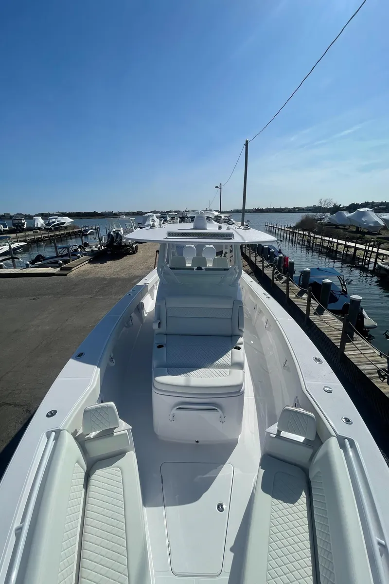 Slide: The Image of 2023 Jupiter 40 boat docked at a marina under a clear blue sky. - 14