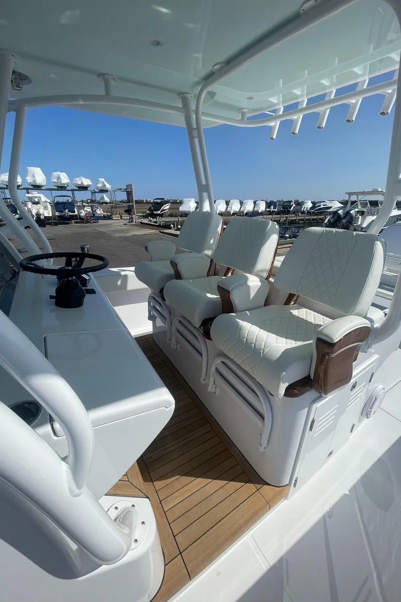 Slide: The Image of Interior of 2023 Jupiter 40 boat with white seating and wooden flooring. - 19