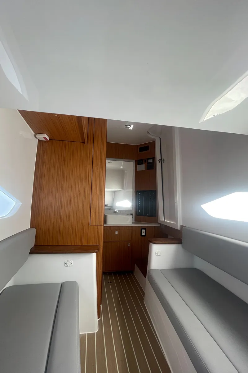 Slide: The Image of Interior cabin of 2023 Jupiter 40 boat with modern wood and white design. - 21