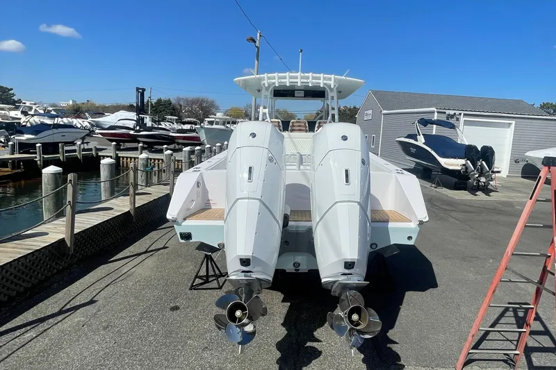 Slide: The Image of 2023 Jupiter 40 boat with dual outboard engines at a marina. - 28
