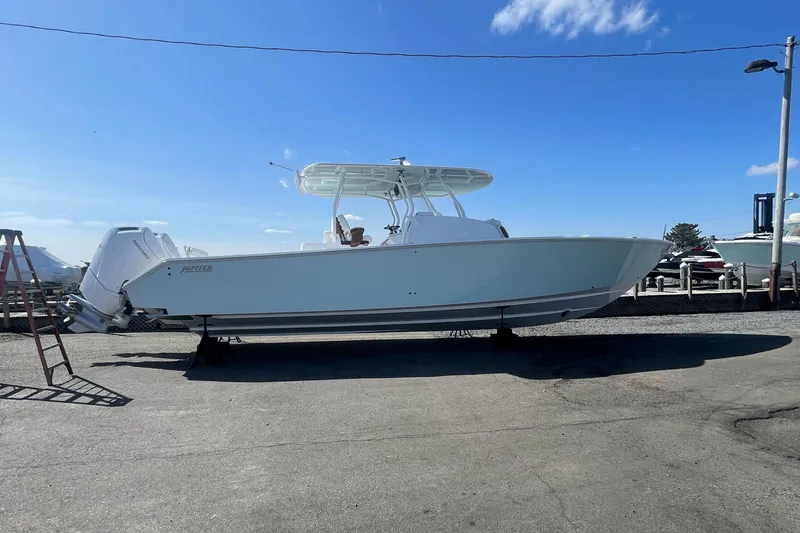 Slide: The Image of 2023 Jupiter 40 boat on display in a marina under a clear blue sky. - 3