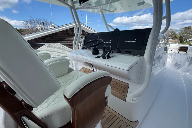 Slide: The Image of Luxurious 2023 Jupiter 40 boat helm with Garmin navigation displays and plush seating. - 30