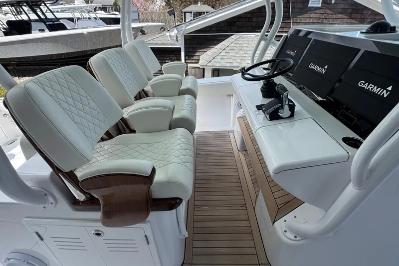 Slide: The Image of Luxurious 2023 Jupiter 40 boat cockpit with plush seating and advanced Garmin navigation system. - 31