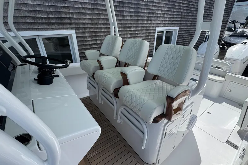Slide: The Image of Luxurious seating on 2023 Jupiter 40 boat with elegant white upholstery and wooden accents. - 33
