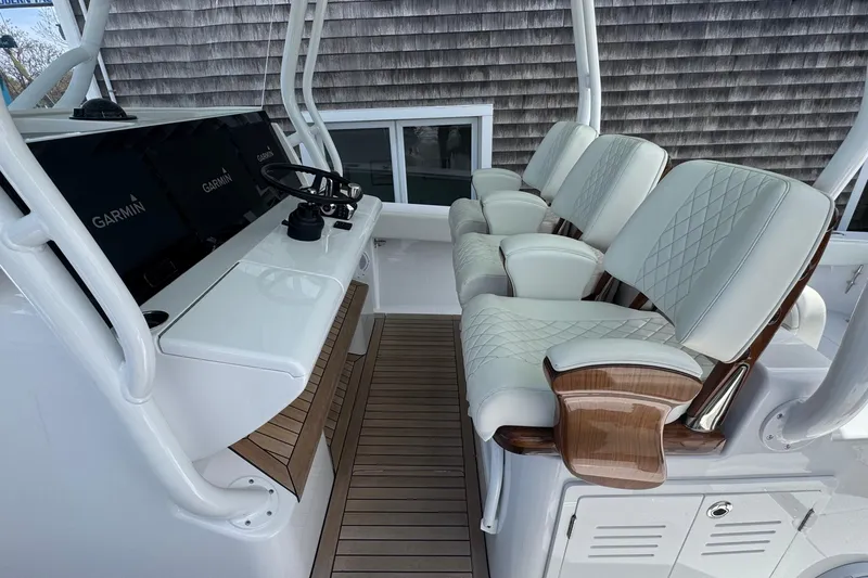 Slide: The Image of Luxurious seating and helm of 2023 Jupiter 40 boat with Garmin displays. - 34