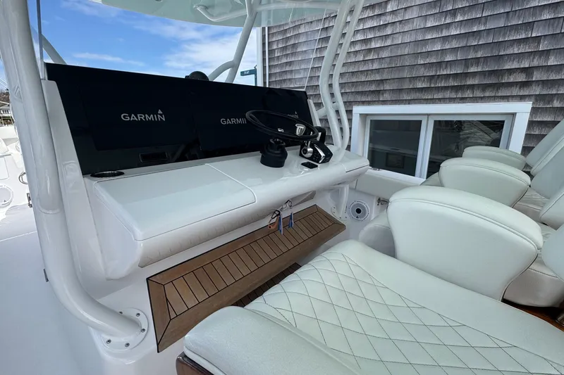 Slide: The Image of Luxurious 2023 Jupiter 40 boat cockpit with Garmin navigation system and plush seating. - 35