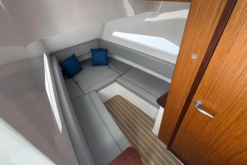 Slide: The Image of Luxurious interior of 2023 Jupiter 40 boat with gray seating and blue cushions. - 36