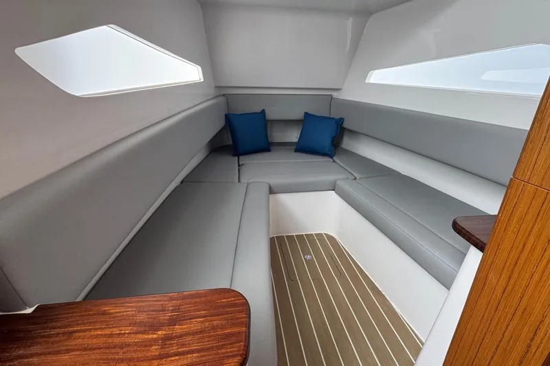 Slide: The Image of Luxurious interior of 2023 Jupiter 40 boat with gray seating and blue cushions. - 37