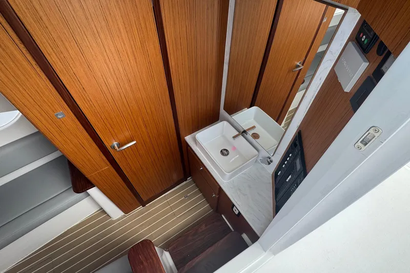 Slide: The Image of Modern bathroom interior on 2023 Jupiter 40 yacht, featuring wood paneling and sleek fixtures. - 40