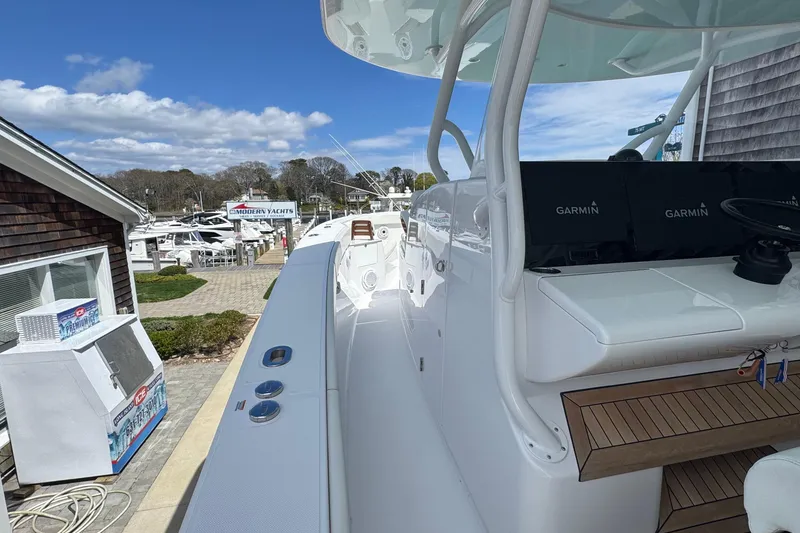 Slide: The Image of 2023 Jupiter 40 boat docked at marina with Garmin equipment. - 42