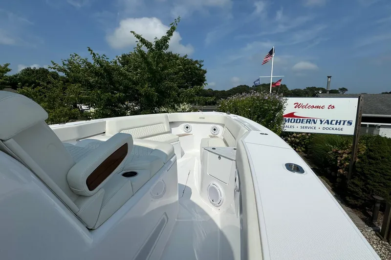 Slide: The Image of 2023 Jupiter 40 yacht at Modern Yachts dealership, showcasing sleek white seating and design. - 44