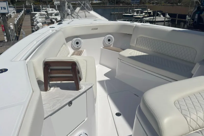 Slide: The Image of Luxurious seating area on a 2023 Jupiter 40 boat, docked at a marina. - 45